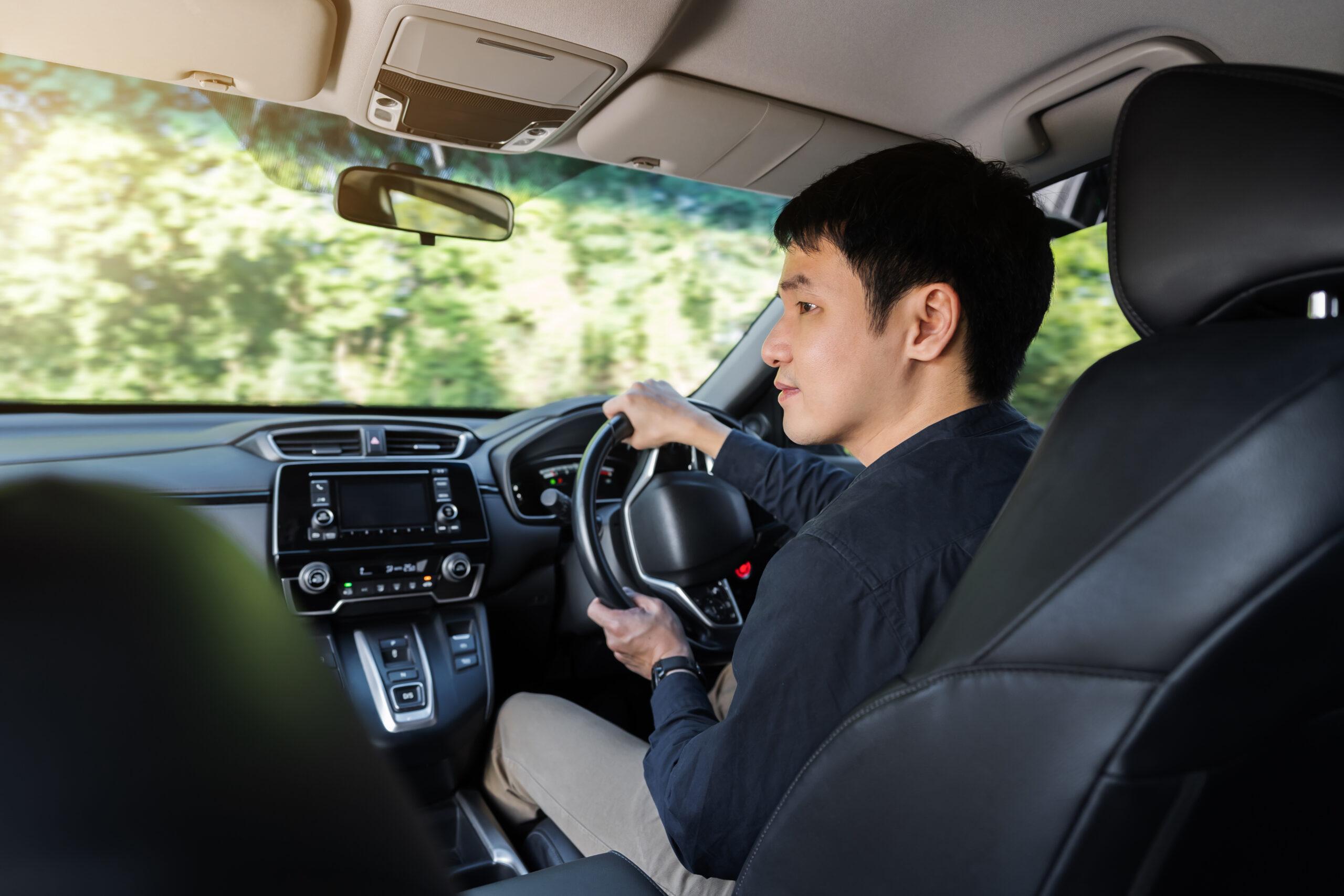 young man driving car scaled